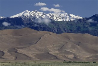 USA, Colorado, Saguache, Great Sand Dunes National Monument. Snow capped mountain landscape behind