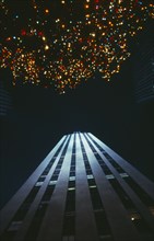 USA, New York State, New York, View looking upwards from the ground at brightly lit christmas tree