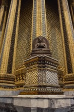 THAILAND, Bangkok, Wat Phra Kaew, Or Grand Palace. Seated buddha statue sitting against golden