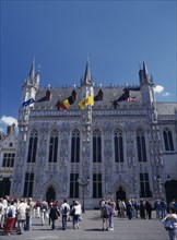 BELGIUM, West Flanders, Bruges, Tourists outside the Stadhius in Burg Square.
