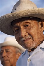 MEXICO, Yucatan, Hoctun, "Two smiling, elderly men in hats, head and shoulders portraits one only