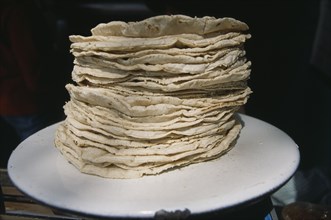 MEXICO, Mexico City, Stack of tortillas on white plate.