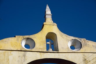 MEXICO, Yucatan, Merida, "City gateway, architectural detail with cross in arched window."