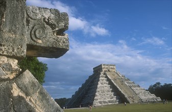 MEXICO, Yucatan, Chichen Itza, Stone carving on the Platform of the Eagles in the foreground with