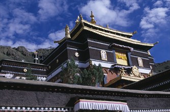 CHINA, Tibet, Shigatse, Tashilhunpo Monastery exterior with golden roof dating from 1447.