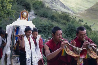 CHINA, Tibet, Lhasa, Drak Yerpa Monastery complex. New statue being carried up to the monastery by