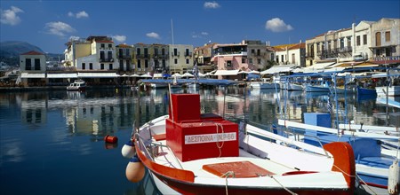 GREECE, Crete, Rethymno, "Venetian Port.  Colourful red, white and blue painted boats moored in