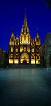 SPAIN, Catalonia, Barcelona, The Cathedral.  Exterior facade and entrance illuminated at dusk.
