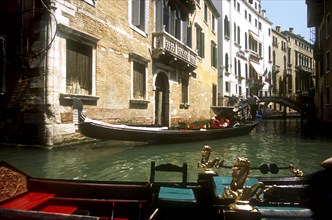 ITALY, Veneto, Venice, Gondolas on narrow canal.