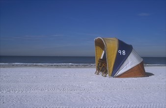 USA, Florida, Clearwater, Clearwater beach with two empty deckchairs shielded by a brightly