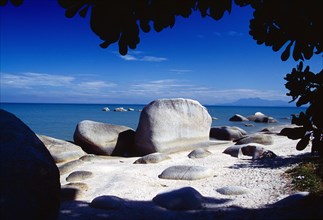 MALAYSIA, Penang, Batu Ferringhi, "Beach and large, smooth rocks part framed by silhouetted tree