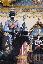 MALAYSIA, Penang, Georgetown, Wat Chayamangkalaram.  Temple guardsman and dragon statues.