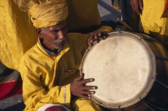PAKISTAN, Punjab, Lahore, Drummer dressed in yellow