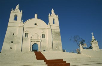 INDIA, Gujarat, Diu, Church of St Thomas. White painted exterior facade with painted red central