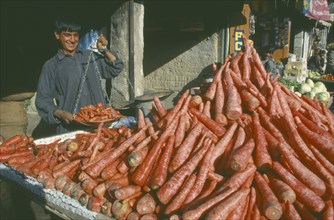 PAKISTAN, Baluchistan, Quetta  , Carrot vendor holding scales