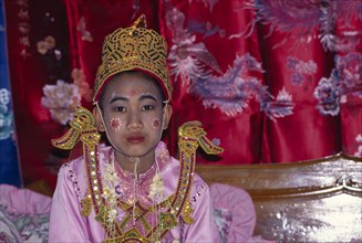 THAILAND, Religion , Buddhism, Novice monk ordination with boy in pink and gold costume and face