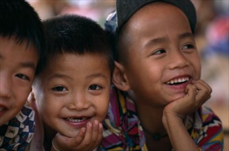 THAILAND, North, Mae Sai, Portrait of three smiling Karen refugee boys