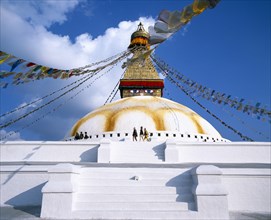 NEPAL, Kathmandu, Bodnath Stupa.  White painted steps leading to dome of stupa painted with eyes