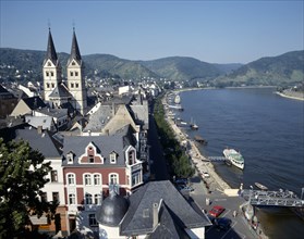 GERMANY, Rhineland, Boppard, Town beside River Rhine. Building with twin towers. Boats moored at