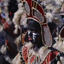 PHILIPPINES, Luzon, Manila, Young girl in costume at Ati-Atihan festival with a black painted face