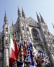 ITALY, Lombardy, Milan, Cathedral frontage with a souvenir stall selling flags and scarves