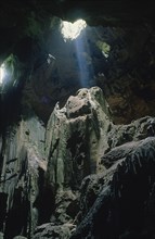 MALAYSIA, Borneo, Kalimantan, Niah Caves interior with light shining through holes in the roof of