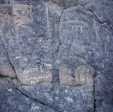 OMAN, Jebel Akhdar, Wadi Sahtan, Rock drawings depicting hunting or battle scene.