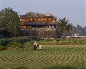 VIETNAM, Central, Hue, "The Citadel, Ngo Mon Gate, workers tending crops in field, trees "