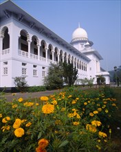 BANGLADESH, Dhaka, Supreme Court Building exterior facade with ornate white arches and orange