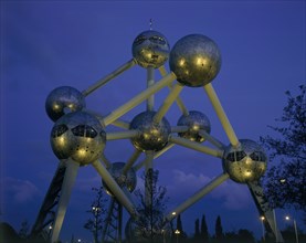 BELGIUM, Brabant, Brussels, The Atomium illuminated at night with lights reflected on the base of