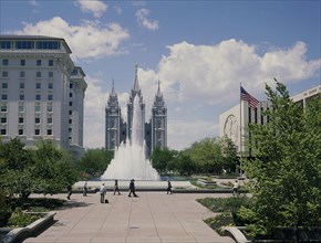 USA, Utah, Salt Lake City, The Mormon Temple beyond the fountain in the gardens with the US flag