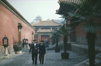 CHINA, Hebei, Beijing, Inside the Forbidden City with chinese couple walking arm in arm