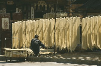 CHINA, Guizhou Province, Kaili, Noodles hanging up to dry.