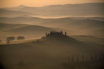 ITALY, Tuscany, San Quirico area, Early misty morning view over the Belvedere