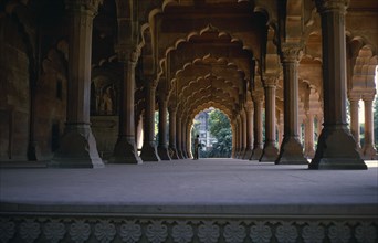 INDIA, Old Delhi, Red Fort, View down colonnade of ornate arches with couple standing at far end.