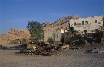 EGYPT, Upper Egypt, Old Qurna, View of traditional housing with a facade mural and donkey tethered