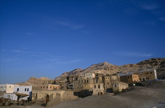 EGYPT, Upper Egypt, Old Qurna, General view of the village buildings with hills behind