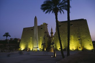 EGYPT, Upper Egypt, Luxor, The Temple Pylons with Obelisk and statues of Ramesses II illuminated at