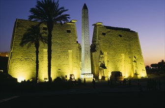 EGYPT, Upper Egypt, Luxor, The Temple Pylons with Obelisk and statues of Ramesses II illuminated at