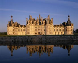 FRANCE, Loire Valley Centre, Loir et Cher, "Chateau Chambord in golden light, reflected in moat in