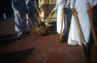 VIETNAM, Tay Ninh Province, Tay Ninh, Cropped view of temple sweepers.