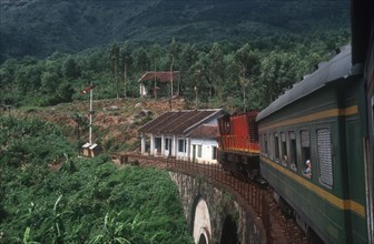 VIETNAM, Hai Van Pass , View from train along carriages as it crosses a bridge surrounded by lush