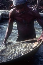 SRI LANKA, Ratnapura, Gem miner panning for gems