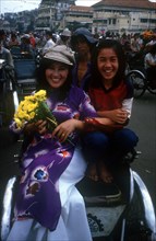 VIETNAM, Ho Chi Minh City, Two young women on a cyclo at Central Market.