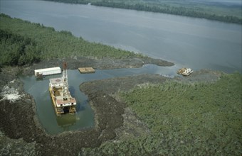 NIGERIA, Rivers State, Bonny, Oil rig in the swamp beside a river