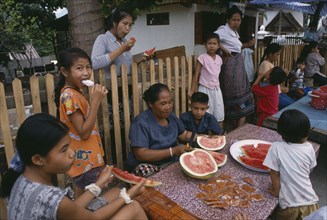 LAOS, Luang Prabang, Family group eating watermelon