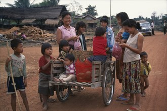 LAOS, Vietianne, Local women and children with handcart on the road to Nam Ngon Dam