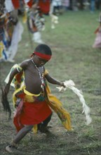 NIGERIA, Festivals, Young Igbo boy in traditional dress dancing