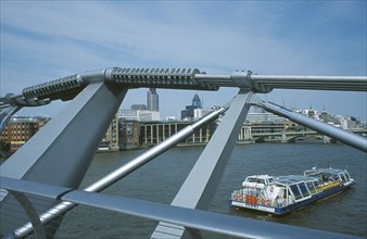 ENGLAND, London, Section of the Millennium footbridge with passing tour boat