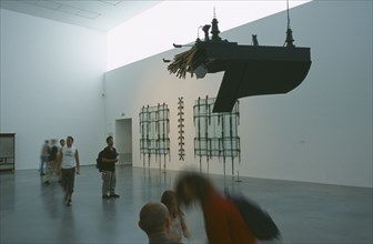 ENGLAND, London, Tate Modern. Modern art exhibition room with piano suspended from the ceiling and